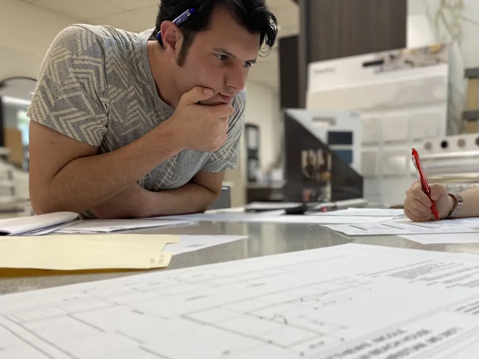 Derek looking at plans with client.